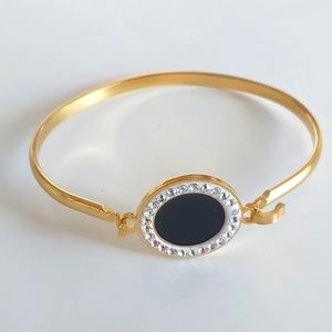 Cuff STAINLESS STEEL BRACELET GOLD. With middle piece black and crystals.